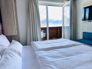 Voodi või voodid majutusasutuse Hotel Lainbach in Wängle toas