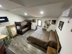 a bedroom with a large bed and a chair at Dimora Forgione B&B - Pietrelcina in Pietrelcina