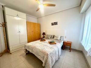 a bedroom with a bed and a ceiling fan at La Mata dream in La Mata