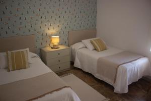 A bed or beds in a room at LUXURY STYLE VILLA AURORA Roche