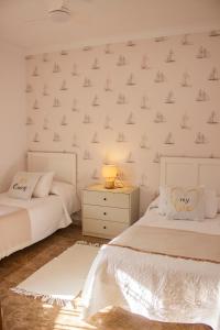 A bed or beds in a room at LUXURY STYLE VILLA AURORA Roche