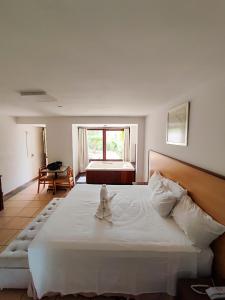 Ένα ή περισσότερα κρεβάτια σε δωμάτιο στο Vila Velluti Hotel +55 φωτογραφίες
