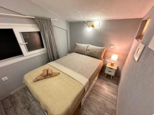 a small bedroom with a bed with a pair of shoes on it at Nikiti Spathies Resort - Double Bedroom Sofita in Kalogria