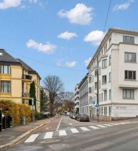 an empty city street with buildings and a crosswalk at Professor Dahls Gate 16 in Oslo +8 photos