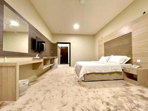 a hotel room with a bed and a television at فندق دلسDELS HoTEL in Tabuk