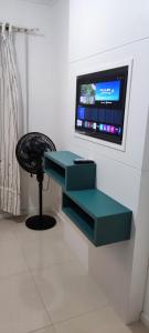 a table and a stool in a room with a tv at AP completo na Praia de Palmas, SC in Governador Celso Ramos +12 photos