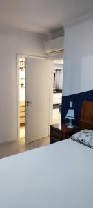 a bedroom with a door leading to a kitchen at AP completo na Praia de Palmas, SC in Governador Celso Ramos
