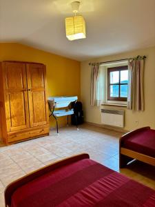 a bedroom with a bed and a desk in it at Gîte lePigeonnier - Ardèche in Aubignas +10 photos
