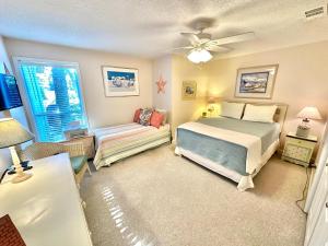 a bedroom with a bed and a window and a couch at 750 Sandpiper in Destin +37 photos