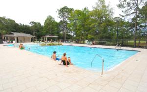 a group of people sitting in a swimming pool at 750 Sandpiper in Destin