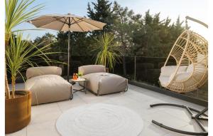 a patio with two chairs and an umbrella at Lovely Home In Zambratija With Kitchen in Zambratija +37 photos
