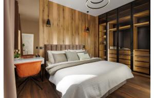 a bedroom with a bed and a wooden wall at Lovely Home In Zambratija With Kitchen in Zambratija