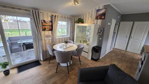 a living room with a table and a couch at Seacottage Brugge - Blankenberge - De Haan in De Haan