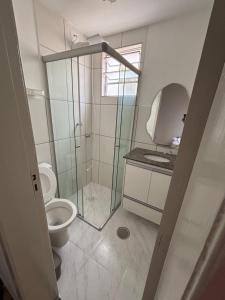 a bathroom with a toilet and a glass shower stall at Apart Pisa in Franca
