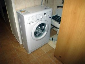 a white washing machine sitting in a room at Penzion u muzea in Příbram