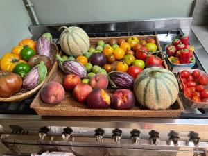 three baskets of fruits and vegetables on a stove at Belle suite au coeur de ville ,petit déjeuner, jardin et bassin in Montpellier +6 photos