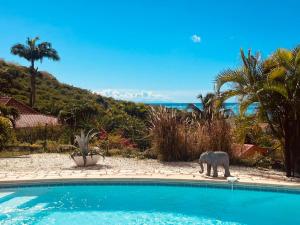 an elephant statue standing next to a swimming pool at Villa Bleue, piscine, vue mer in Le Diamant