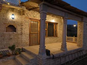 a stone house with a porch at night at Virasat homestay in Chanderi