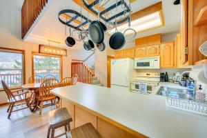 a kitchen and dining room with a table and chairs at Fish and Bike Lake Pend Oreille Gem with Hot Tub! in Athol