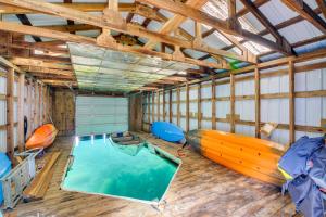 a room with a pool and a boat in it at Fish and Bike Lake Pend Oreille Gem with Hot Tub! in Athol