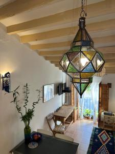 a stained glass chandelier hanging in a living room at Oldtown family house with amazing terrace - 3 minutes from beach! in Villajoyosa