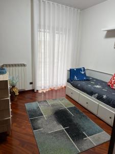 a bedroom with a bed and a large window at Marebleuhouse in Naples