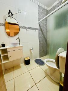 a bathroom with a toilet and a sink and a mirror at LAquolina in Socorro