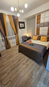 a bedroom with a large bed in a room at Corner Studio Unit Condo in Bacolod