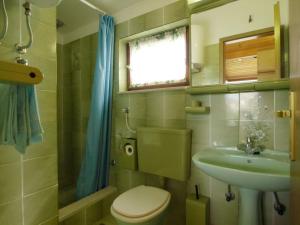 a small bathroom with a toilet and a sink at Apartments Lukoran in Lukoran
