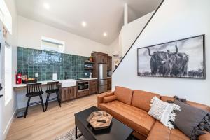 a living room with a couch and a cow on the wall at Zion Oasis Rentals in Hurricane