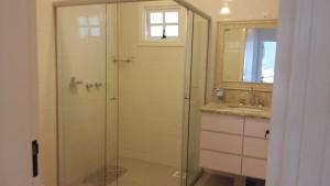 a shower with a glass door in a bathroom at A Casa Serena in Morro Reuter +41 photos