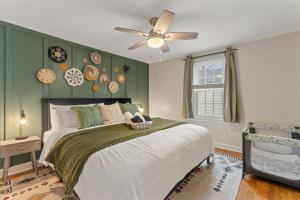 a bedroom with a bed and a ceiling fan at 5 Mins to UND - Cozy 4BD with BBQ & Pool Table in South Bend