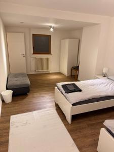 a bedroom with a bed and a flat screen tv at Rebhof Bahlingen Ferienwohnung Nr 17 Silvaner in Bahlingen