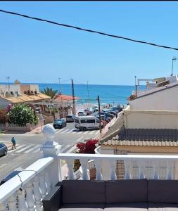 a balcony with a view of a parking lot and the ocean at Casa La Mata in Torrevieja +5 photos
