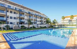 a large swimming pool in front of a building at 1 Bedroom Lovely Apartment In Denia in Denia +13 photos
