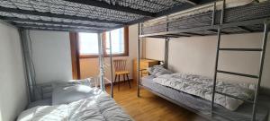 a room with three bunk beds and a desk at Résidence Le Dôme - maeva Home - Appartement 3 pièces 6 personnes - Confort MAE-6221 in La Mongie