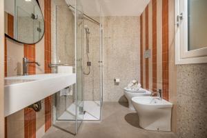 a bathroom with a sink and a toilet at Villa Orizzonte in Scopello +21 photos