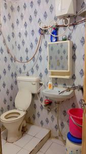 a bathroom with a toilet and a sink at Family Homestay near Sangam in Prayagraj