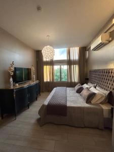 a bedroom with a large bed and a large window at Armonium Airport in Ezeiza