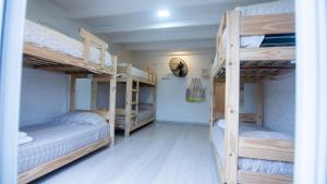 a room with three bunk beds in a house at Casa Amonite Hostel Boutique in Puerto Madryn