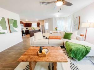 a living room with a white couch and a table at Family Modern Oasis Lackland BMT Family Home 3 Bed 2 Bath in San Antonio