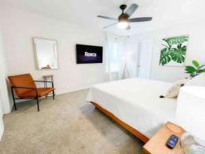 a bedroom with a bed and a tv on the wall at Family Modern Oasis Lackland BMT Family Home 3 Bed 2 Bath in San Antonio