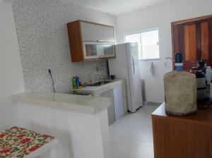 カボ・フリオにあるOndas do Peróのシンクと白い冷蔵庫のあるキッチン