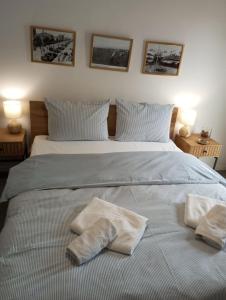 a bedroom with a bed with two towels on it at In the heart of Alexandroupolis in Alexandroupoli