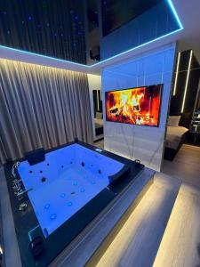 a large pool table with a fireplace in a living room at Wiślane Tarasy 2 VIP Apartamenty JACUZZI in Krakow