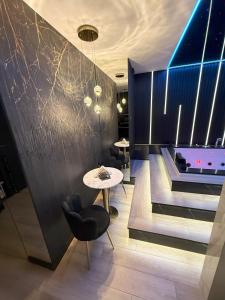 a dining room with a ping pong table and a pool at Wiślane Tarasy 2 VIP Apartamenty JACUZZI in Krakow +5 photos