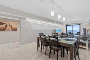 a dining room with a table and chairs at 317 - Fantastic 3 BR Oceanfront Corner in Edgewater