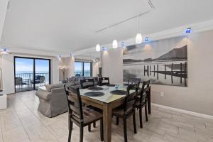 a dining room and living room with a table and chairs at 317 - Fantastic 3 BR Oceanfront Corner in Edgewater