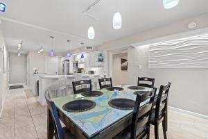 a kitchen and dining room with a table and chairs at 317 - Fantastic 3 BR Oceanfront Corner in Edgewater