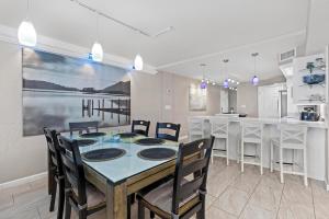 a dining room and kitchen with a table and chairs at 317 - Fantastic 3 BR Oceanfront Corner in Edgewater +50 photos